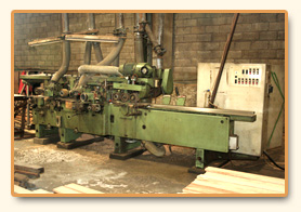 Radial arm saw with sawn stock alongside.