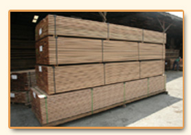Sawn planks bundled and stacked in the yard.