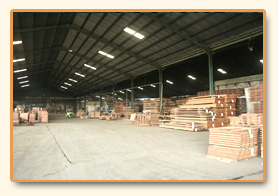 Warehouse interior with stock staged along the walls.