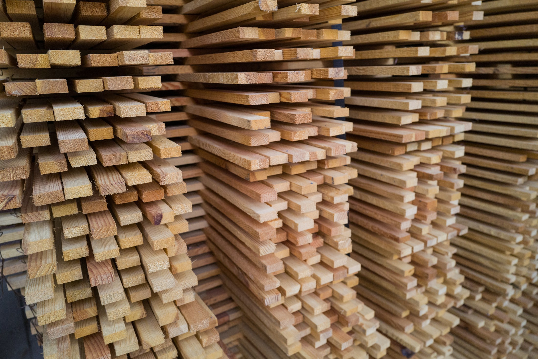 Sawn hardwood timber, stacked and dressed to profile.